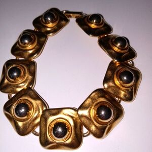 VintageHeavy gold tone.Big links well made  silver like accents  bracelet unisex
